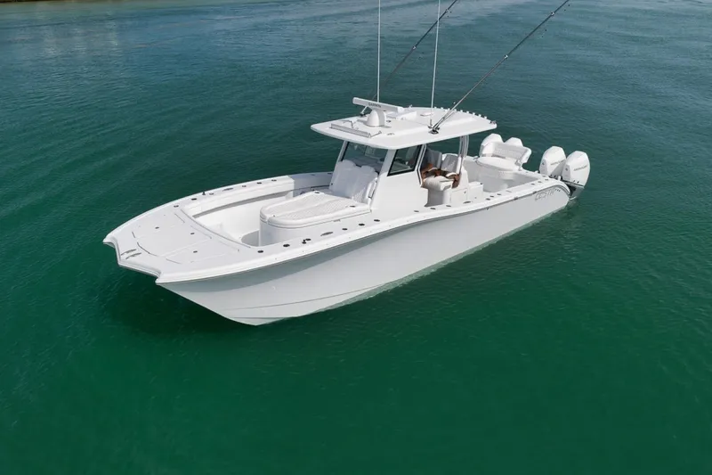 Slide: The Image of 2024 Costa Custom Boats 34SV on calm water, showcasing sleek design and triple engines. - 11