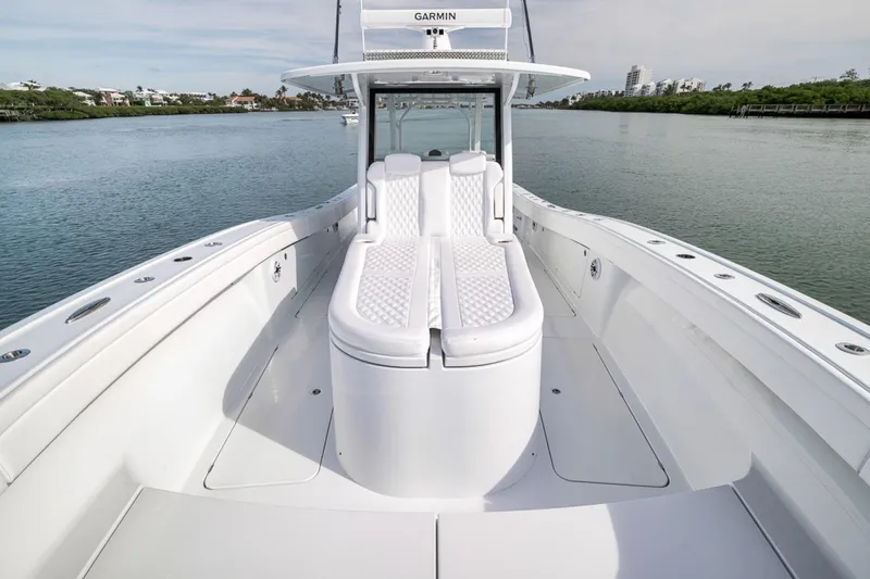 Slide: The Image of 2024 Costa Custom Boats 34SV, sleek white deck, luxurious seating, calm waters in background. - 15