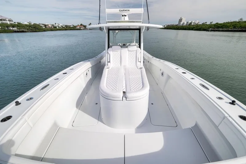 Slide: The Image of 2024 Costa Custom Boats 34SV on calm water, showcasing sleek design and spacious deck. - 16
