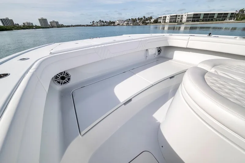 Slide: The Image of 2024 Costa Custom Boats 34SV interior with white seating and waterfront view. - 17