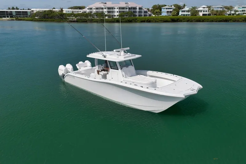 Slide: The Image of 2024 Costa Custom Boats 34SV on calm water, showcasing sleek design and triple engines. - 2