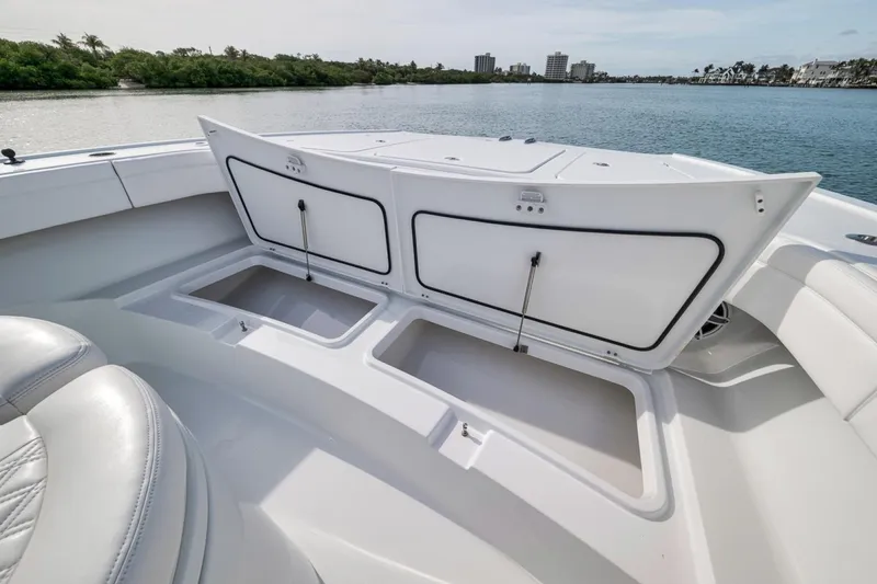 Slide: The Image of 2024 Costa Custom Boats 34SV open storage compartments on deck, with scenic water view. - 20