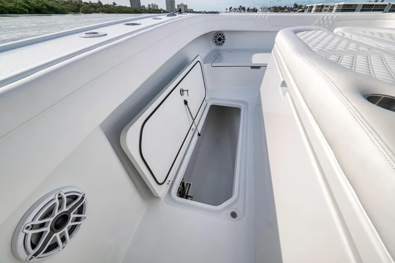 Slide: The Image of 2024 Costa Custom Boats 34SV interior storage compartment with speakers and seating. - 25