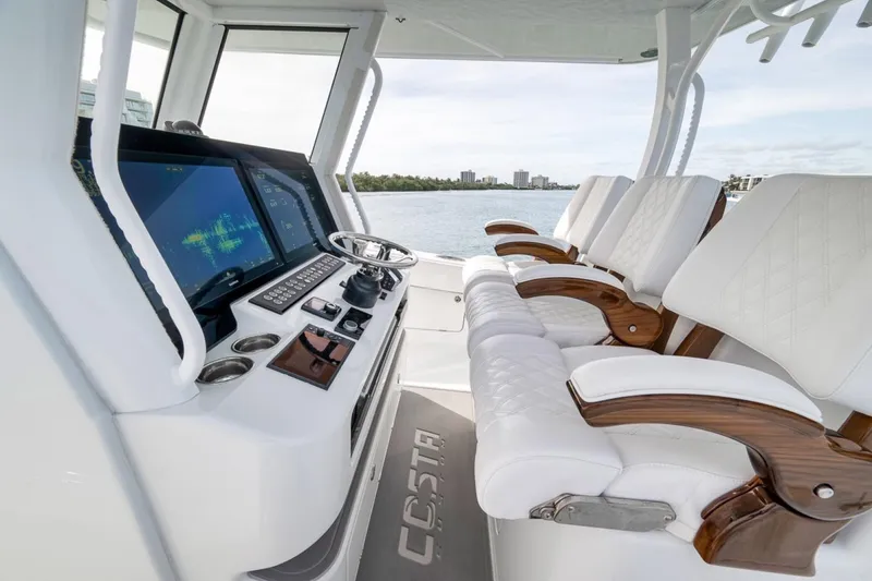 Slide: The Image of 2024 Costa Custom Boats 34SV cockpit with luxury seating and advanced navigation displays. - 27