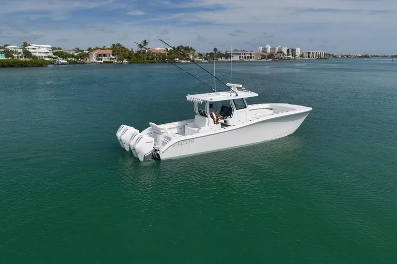 Slide: The Image of 2024 Costa Custom Boats 34SV on calm water, showcasing sleek design and triple engines. - 4