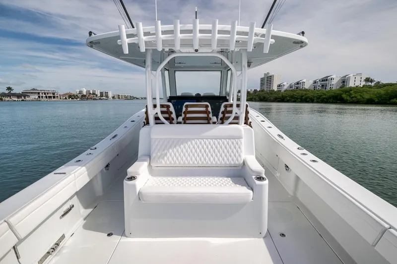 Slide: The Image of 2024 Costa Custom Boats 34SV on calm water, showcasing sleek design and seating. - 44