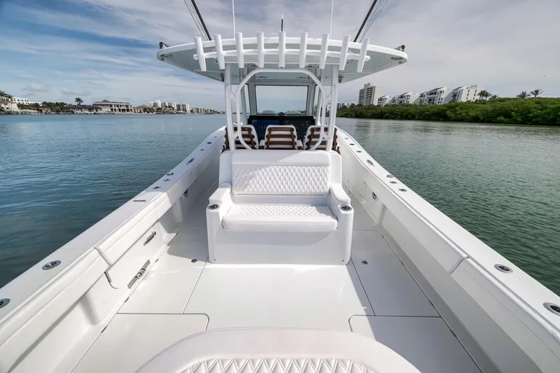 Slide: The Image of 2024 Costa Custom Boats 34SV on calm water, showcasing sleek design and spacious deck. - 45