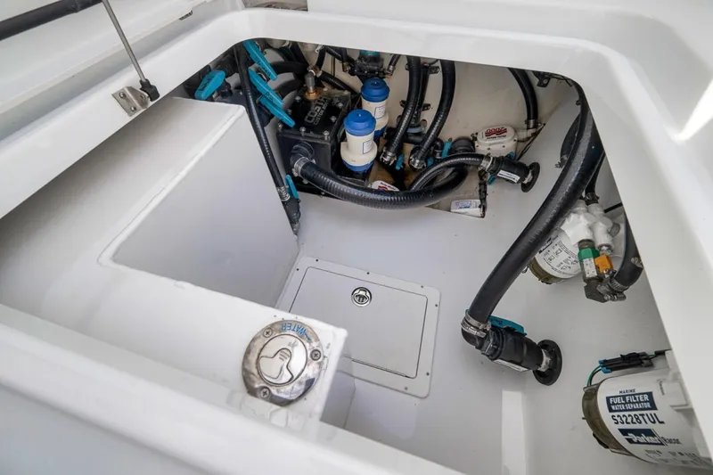 Slide: The Image of Engine compartment of 2024 Costa Custom Boats 34SV, showcasing fuel filters and hoses. - 46