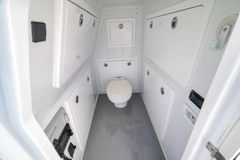 Slide: The Image of 2024 Costa Custom Boats 34SV interior bathroom with white cabinetry and modern fixtures. - 49