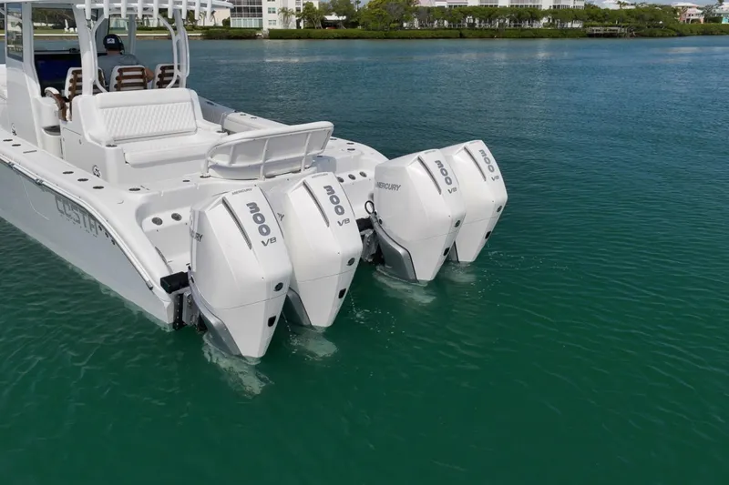 Slide: The Image of 2024 Costa Custom Boats 34SV with triple Mercury 300 V8 engines on calm water. - 5