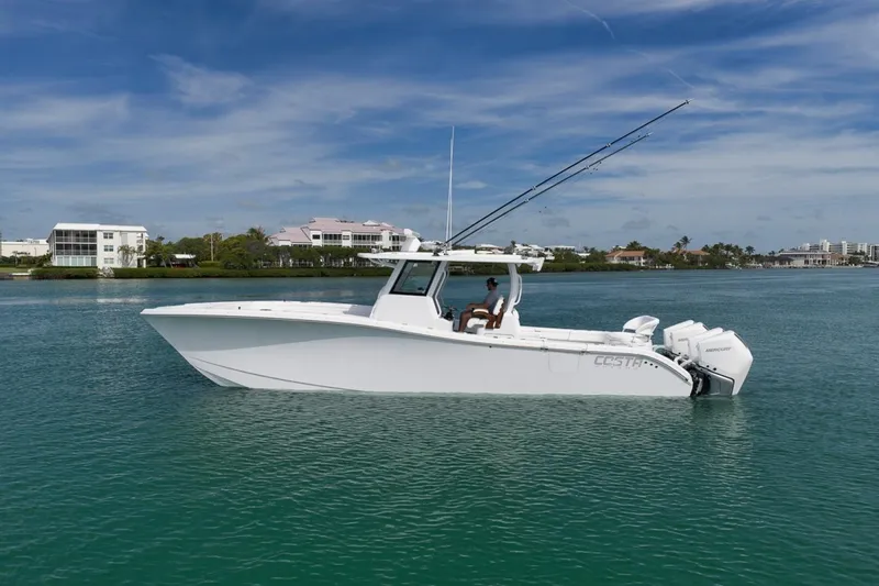 Slide: The Image of 2024 Costa Custom Boats 34SV on calm water, showcasing sleek design and powerful engines. - 8