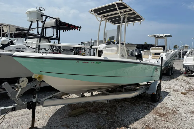 The Image of 2017 Mako 19 CPX boat on trailer in a marina setting. - 1