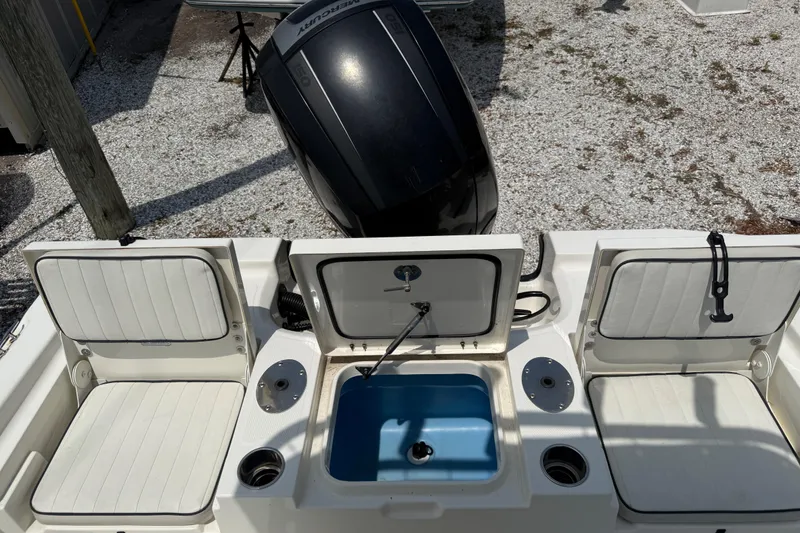 Slide: The Image of 2017 Mako 19 CPX boat interior with seating and Mercury outboard motor. - 11