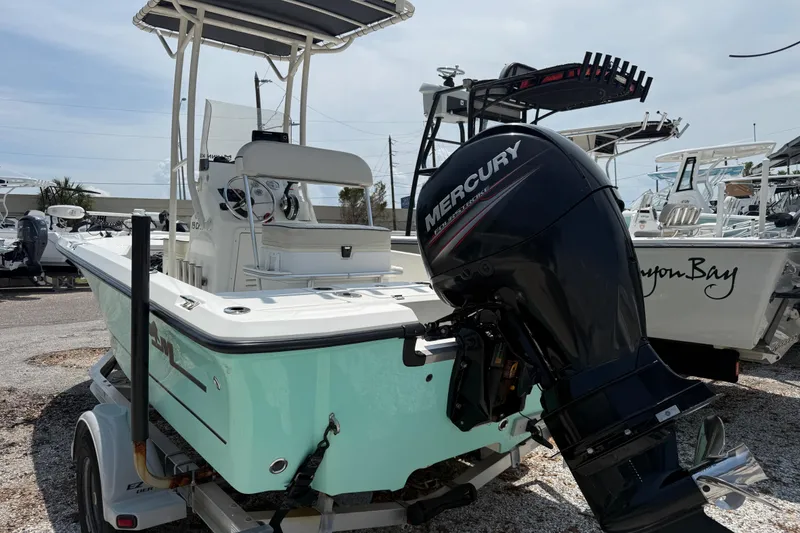 Slide: The Image of 2017 Mako 19 CPX boat with Mercury engine on trailer, parked outdoors. - 4
