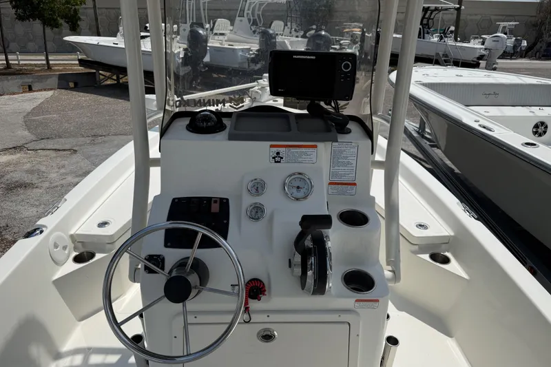 Slide: The Image of 2017 Mako 19 CPX boat console with steering wheel and navigation equipment. - 6