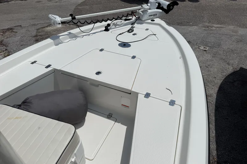 Slide: The Image of 2017 Mako 19 CPX boat deck with storage compartments and trolling motor. - 7