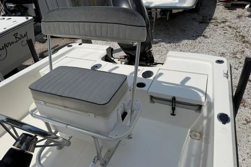 Slide: The Image of 2017 Mako 19 CPX boat interior with cushioned seating and storage compartments. - 9