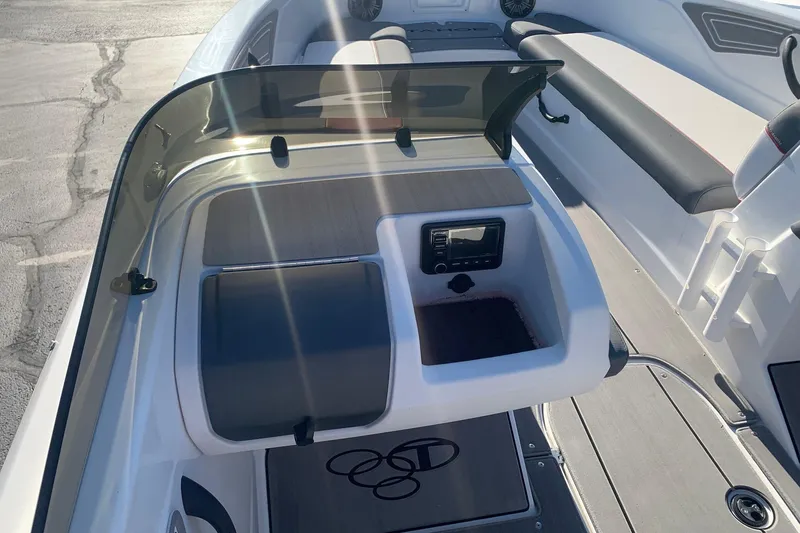 Slide: The Image of 2023 Tahoe T21 boat interior with dashboard and seating area in sunlight. - 7