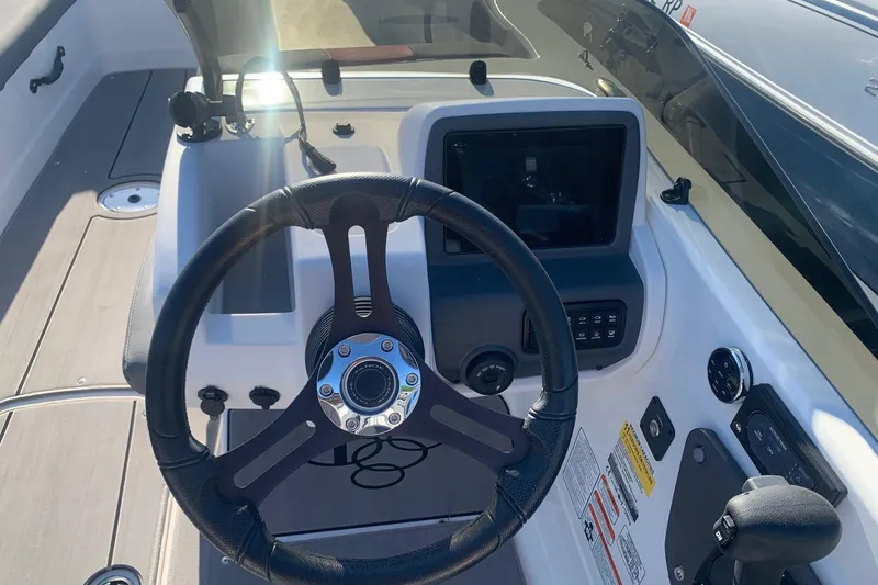 Slide: The Image of Steering console of 2023 Tahoe T21 boat with modern controls and dashboard. - 8