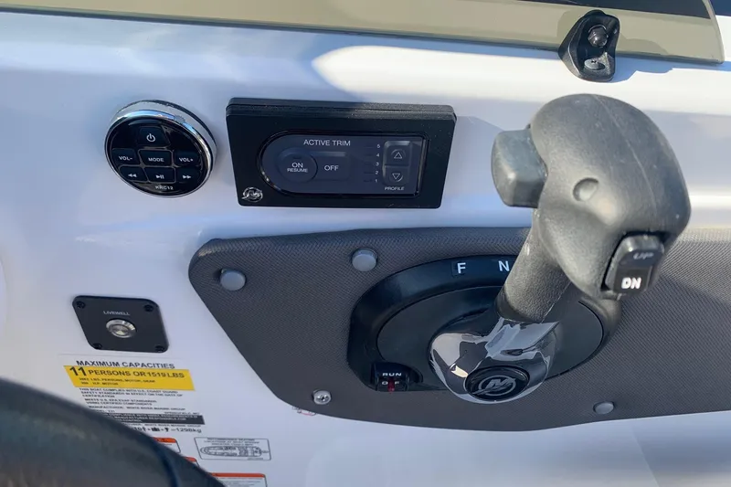 Slide: The Image of Control panel of 2023 Tahoe T21 boat with throttle and trim settings. - 9