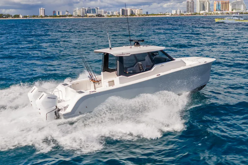 Slide: The Image of 2026 Hammer Yachts 35HH cruising on ocean near city skyline. - 1