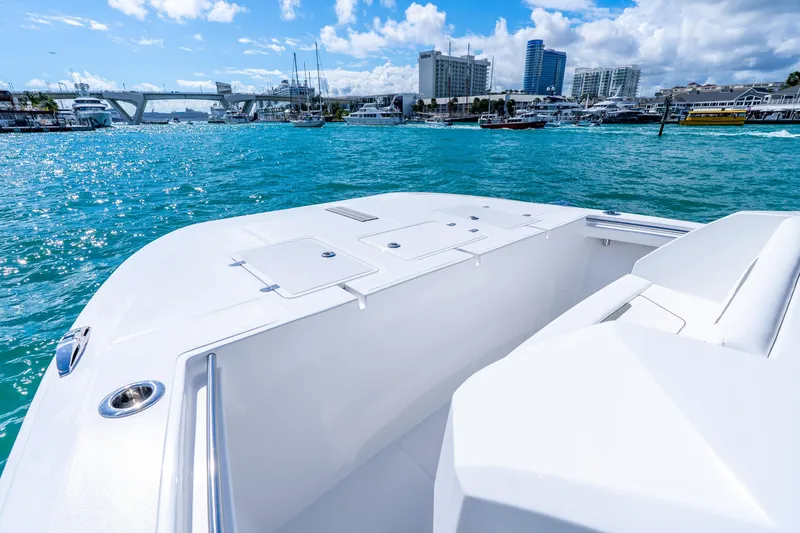 Slide: The Image of 2026 Hammer Yachts 35HH on vibrant blue water with city skyline backdrop. - 11