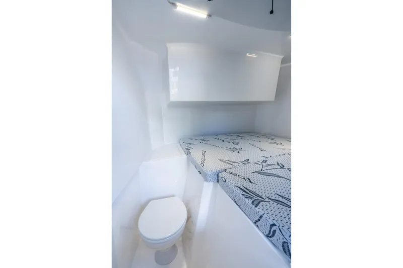 Slide: The Image of Interior of 2026 Hammer Yachts 35HH, featuring compact toilet and bed with patterned bedding. - 37