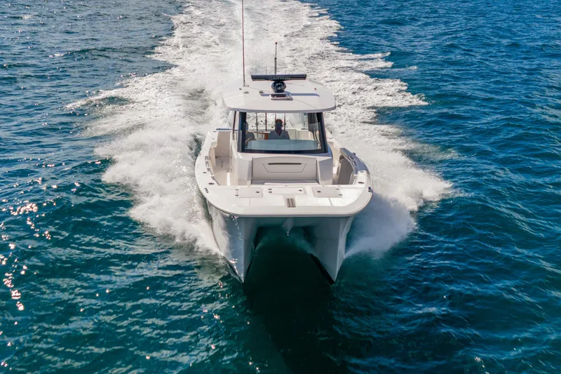 Slide: The Image of 2026 Hammer Yachts 35HH cruising on open water, creating a dynamic wake. - 7