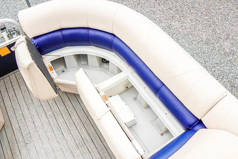 Slide: The Image of 2012 Xcursion X21C pontoon boat with open storage under cushioned seating. - 11