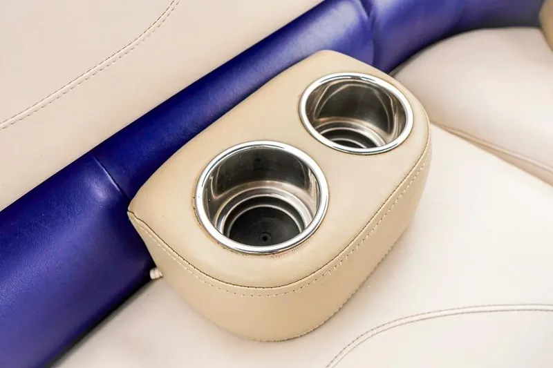 Slide: The Image of Cup holders on beige and blue seating in 2012 Xcursion X21C boat interior. - 13