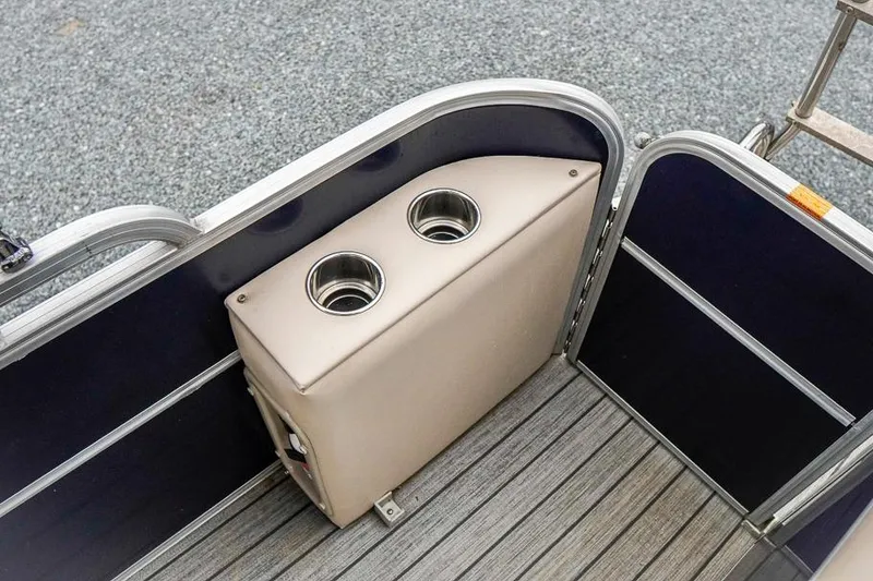 Slide: The Image of 2012 Xcursion X21C boat interior with dual cup holders and sleek design. - 14