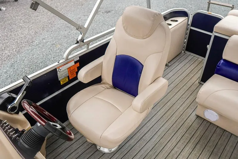 Slide: The Image of Captain's chair on 2012 Xcursion X21C pontoon boat with beige and blue upholstery. - 15