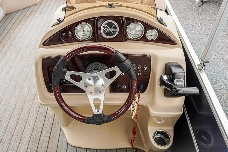Slide: The Image of Steering console of 2012 Xcursion X21C boat with gauges and controls. - 16