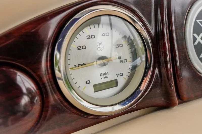 Slide: The Image of Close-up of a 2012 Xcursion X21C RPM gauge on a wooden dashboard. - 18