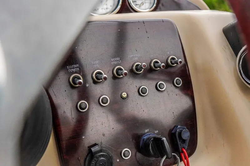 Slide: The Image of Control panel of a 2012 Xcursion X21C boat with switches and gauges. - 20