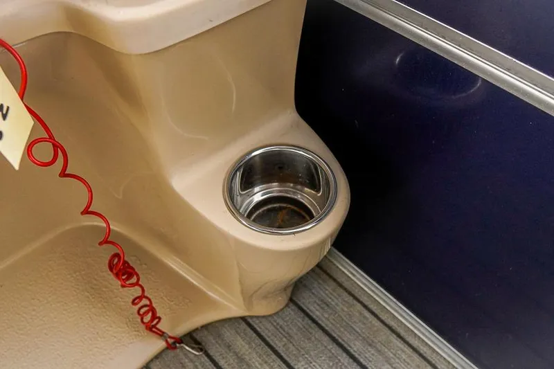 Slide: The Image of Cup holder in 2012 Xcursion X21C boat interior with red coiled cord. - 21