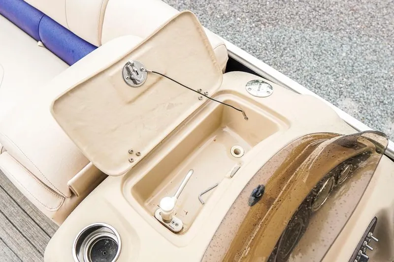 Slide: The Image of 2012 Xcursion X21C boat console with open storage compartment and cup holder. - 22