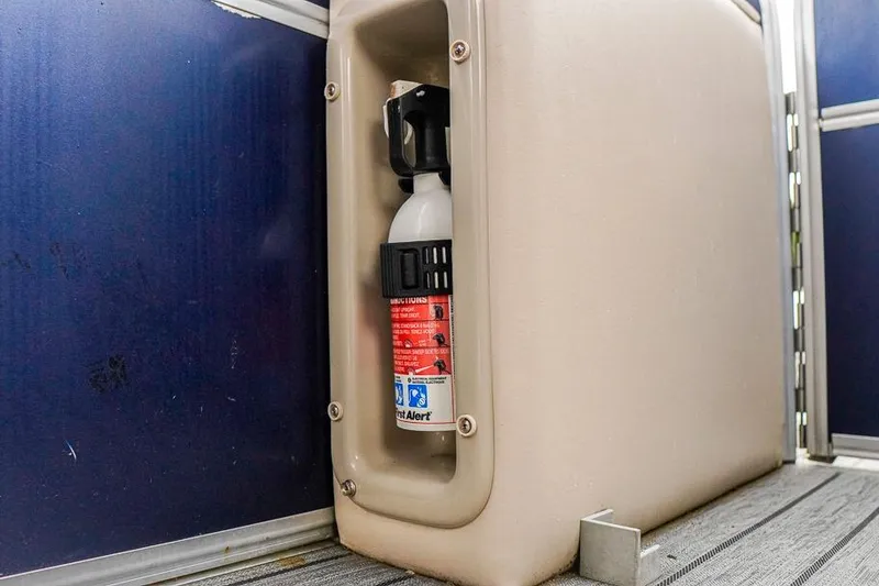 Slide: The Image of Fire extinguisher mounted on 2012 Xcursion X21C boat interior. - 24