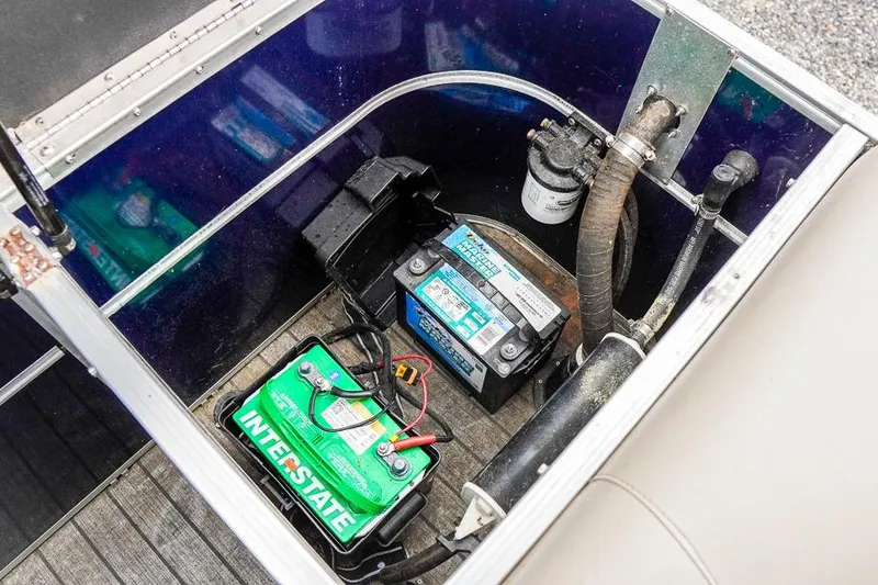 Slide: The Image of Battery compartment of 2012 Xcursion X21C boat with Interstate battery and wiring. - 26