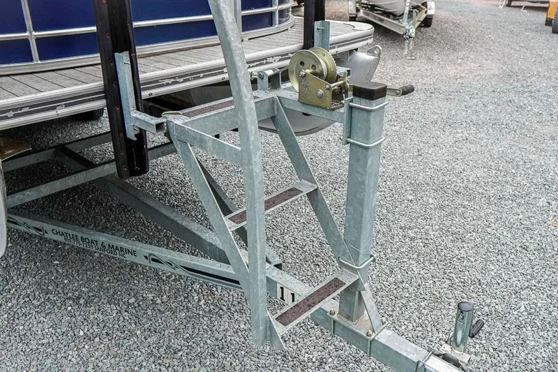 Slide: The Image of Trailer hitch and winch system for 2012 Xcursion X21C boat on gravel surface. - 28
