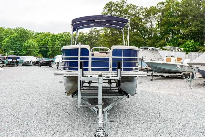 Slide: The Image of 2012 Xcursion X21C pontoon boat on trailer in outdoor storage area. - 3