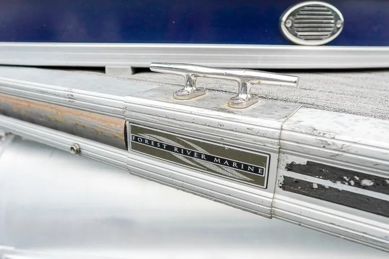 Slide: The Image of 2012 Xcursion X21C boat detail with Forest River Marine branding and metal cleat. - 32