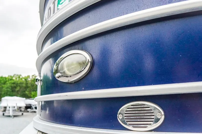 Slide: The Image of Close-up of a 2012 Xcursion X21C boat's blue exterior with light and vent. - 33