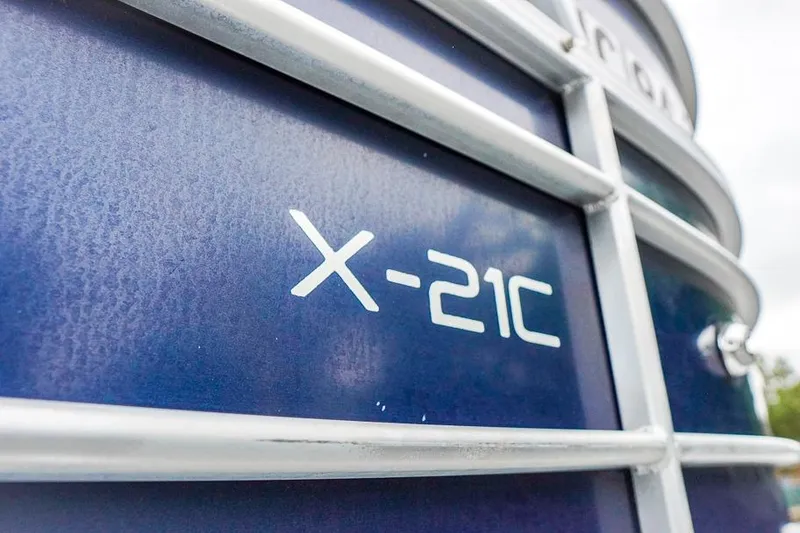 Slide: The Image of Close-up of 2012 Xcursion X21C boat exterior with model name. - 34
