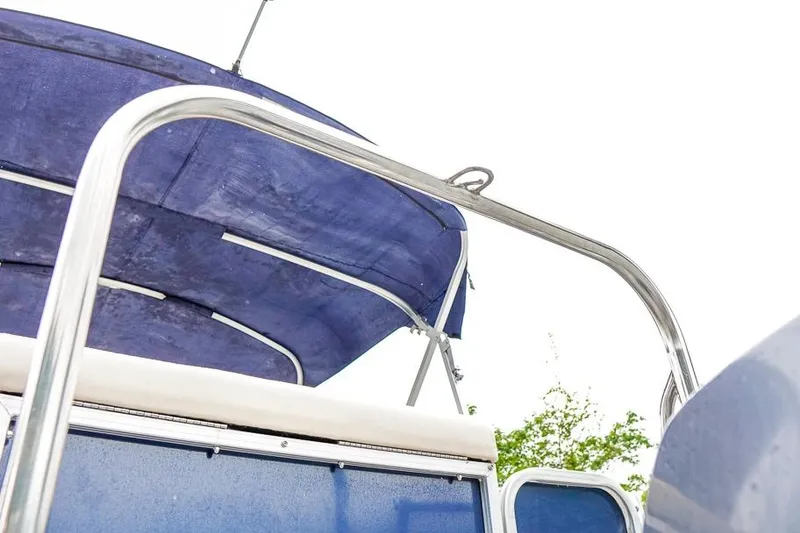Slide: The Image of 2012 Xcursion X21C boat with blue canopy and stainless steel railing. - 35