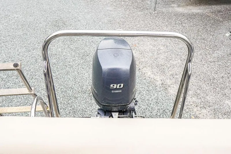 Slide: The Image of Outboard motor on 2012 Xcursion X21C boat, featuring Yamaha 90 horsepower engine. - 36