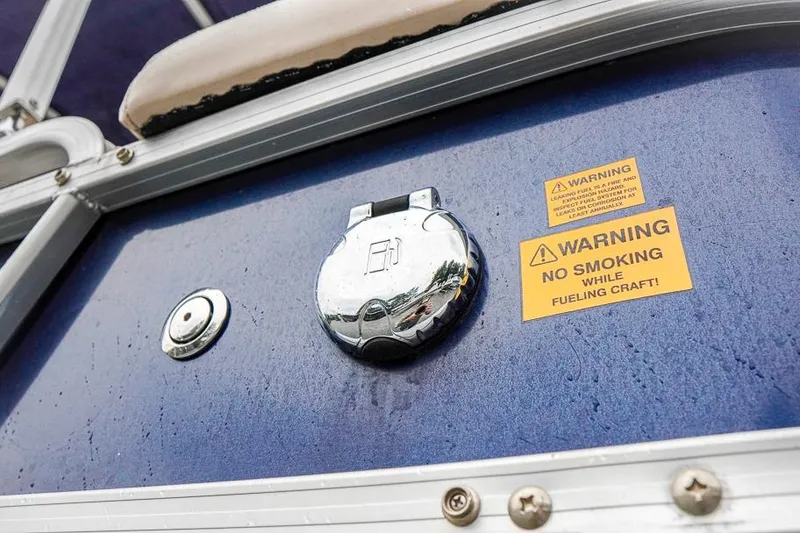 Slide: The Image of 2012 Xcursion X21C boat fuel cap with safety warning labels. - 38