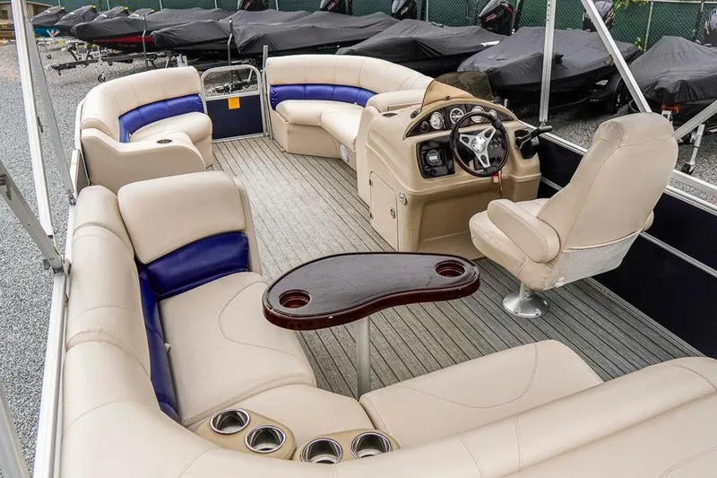 Slide: The Image of Luxurious 2012 Xcursion X21C pontoon boat interior with plush seating and modern dashboard. - 6