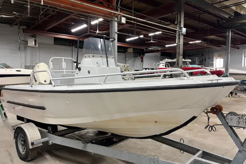 The Image of 1995 Boston Whaler Justice boat on trailer in indoor storage facility. - 0