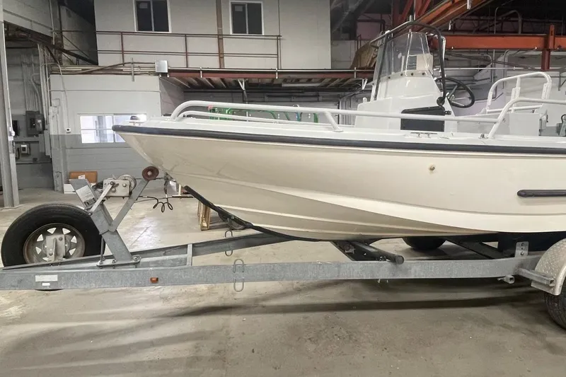Slide: The Image of 1995 Boston Whaler Justice boat on trailer in indoor storage facility. - 4